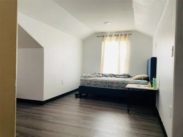 a room with a couch and a wooden floor