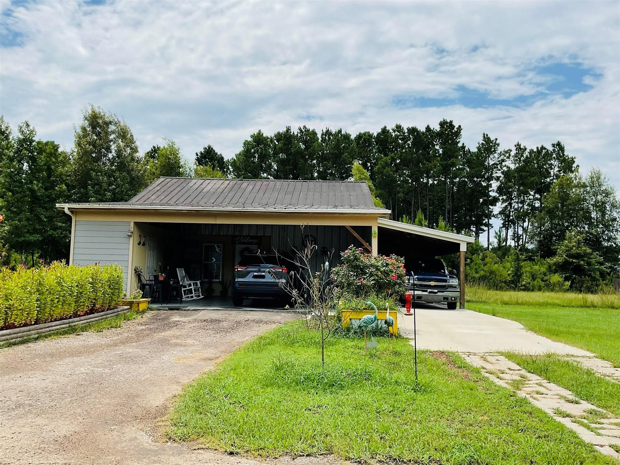 76 County Road 3540 Cleveland, TX 77327 - Photo 2 of 26 a view of a chair and table in the garden and yard