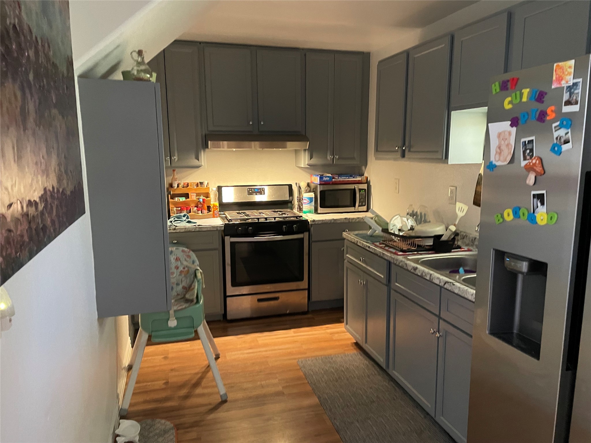 76 County Road 3540 Cleveland, TX 77327 - Photo 22 of 26 a kitchen with stainless steel appliances kitchen island granite countertop a refrigerator stove and sink