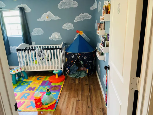 a bedroom with a bed a dresser and a mirror