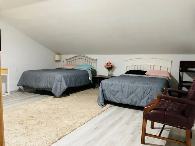 a bedroom with a bed and a wall painting