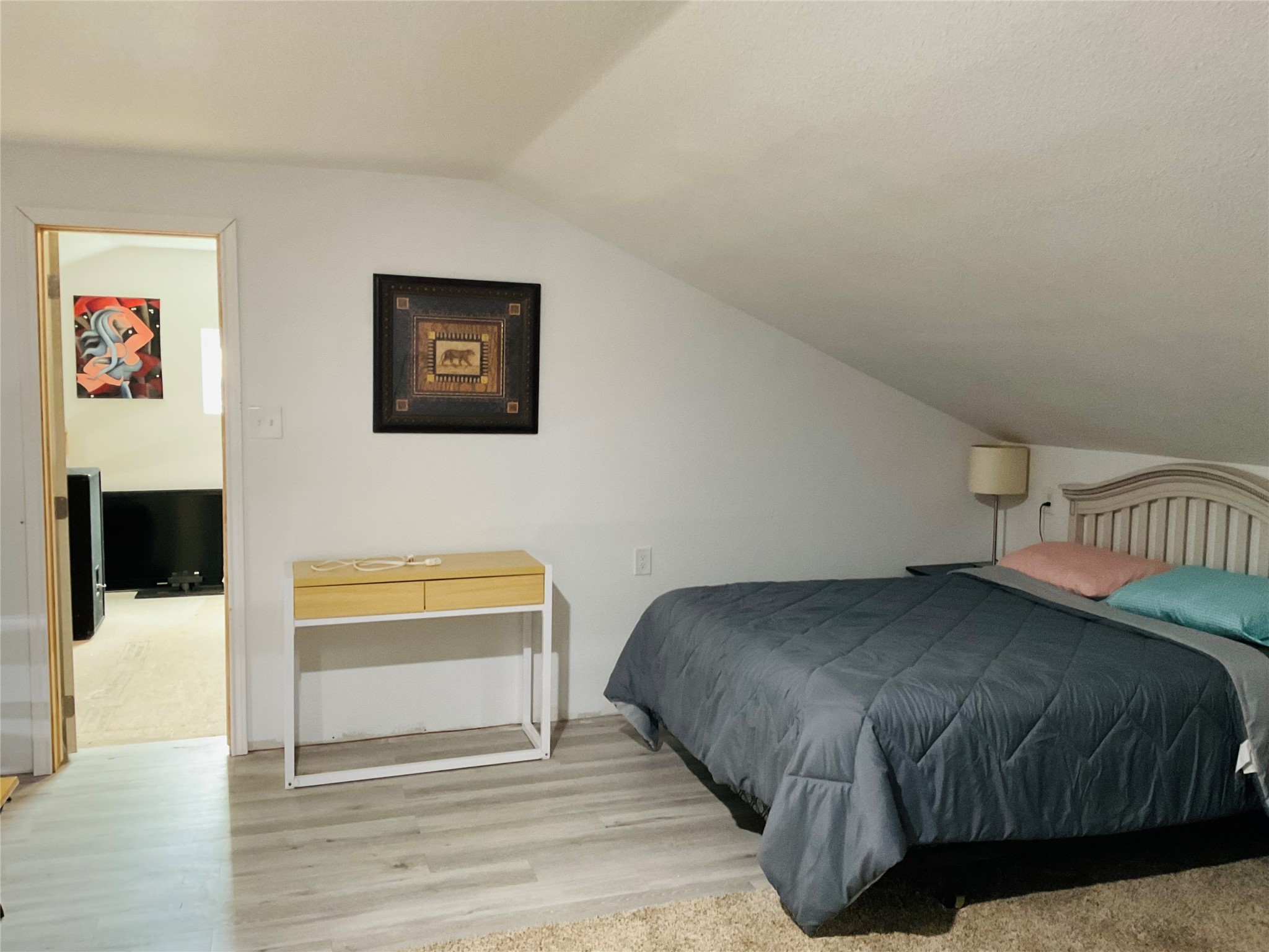 76 County Road 3540 Cleveland, TX 77327 - Photo 8 of 26 a bedroom with a bed and a wall painting