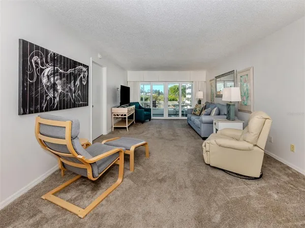 a living room with furniture a rug and a window
