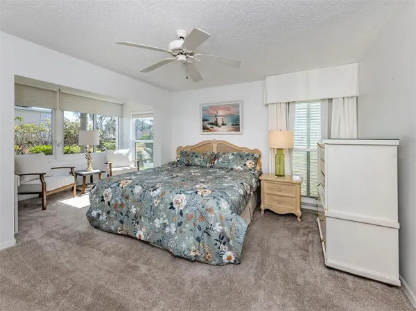 a bedroom with a bed mirror and window