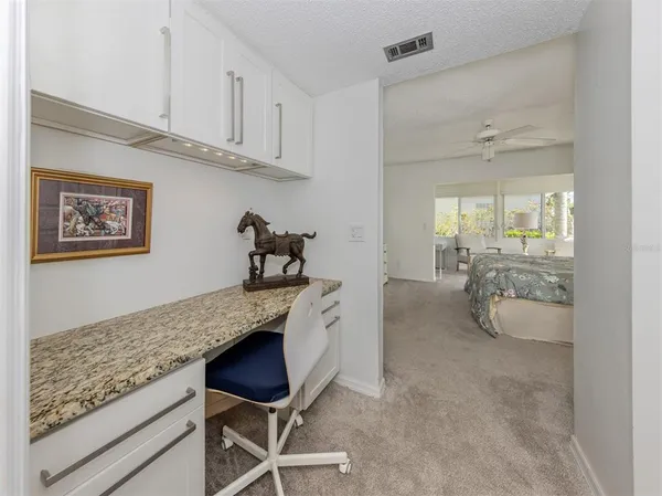 a spacious bathroom with a granite countertop sink and a mirror