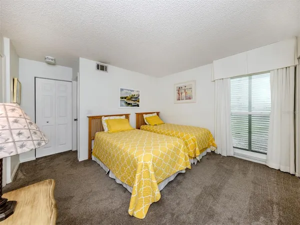 a bed sitting in a bedroom next to a window
