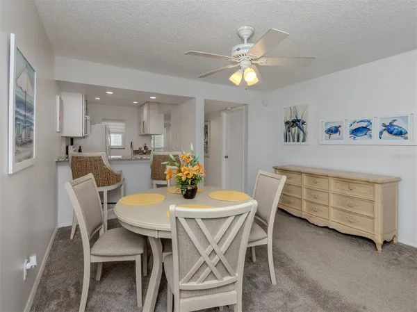 a view of a dining room with furniture and chandelier