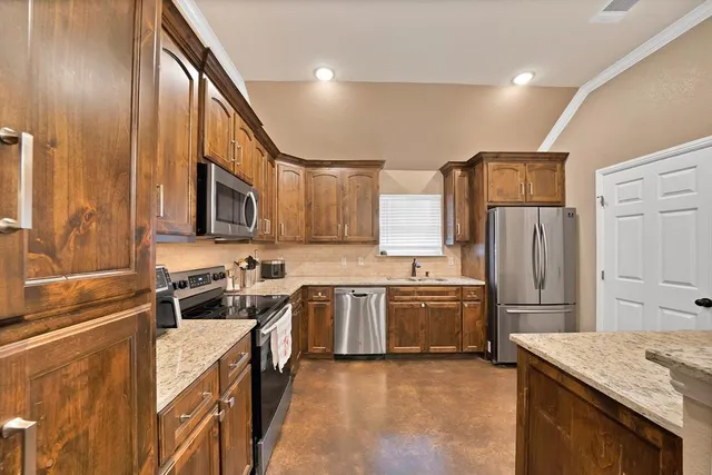 a kitchen with a sink stove and refrigerator