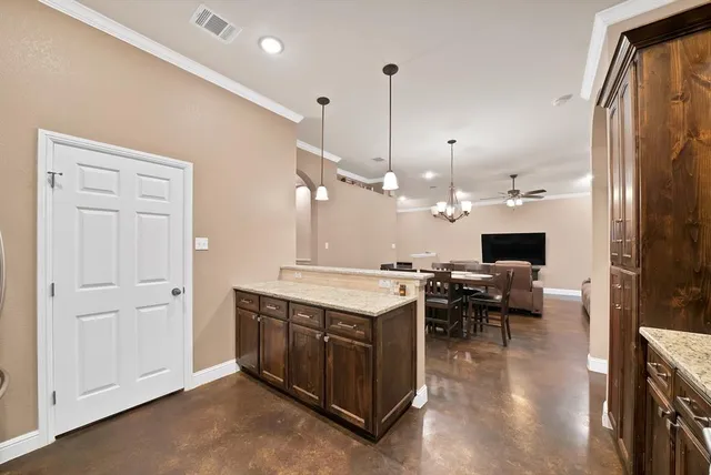 a open kitchen with stainless steel appliances granite countertop a stove and a refrigerator