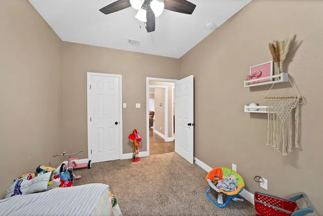 a bedroom with furniture and a chandelier