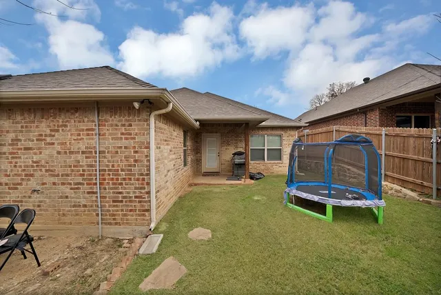 a view of a house with a yard and garage