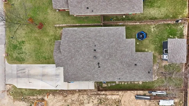 an aerial view of a house with a yard