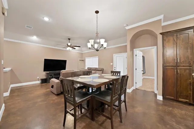 a view of a dining room with furniture and a chandelier