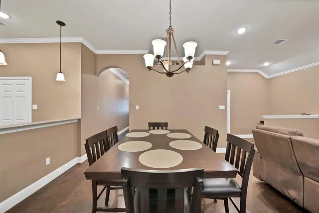 a view of a dining room with a table and chairs