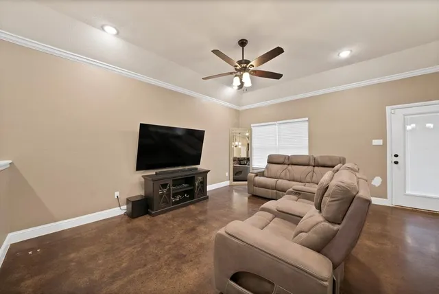 a living room with furniture and a flat screen tv