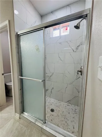 a bathroom with a glass shower door