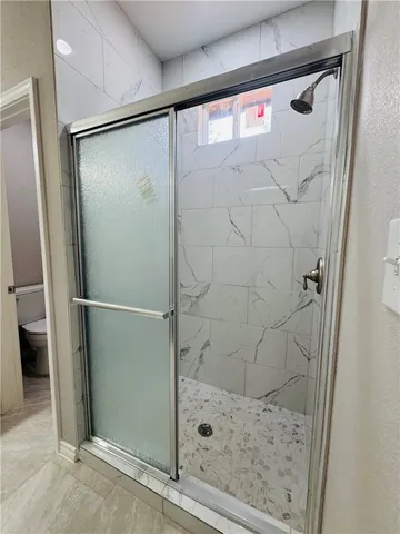 a bathroom with a glass shower door