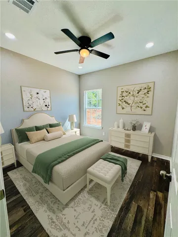 a bedroom with a bed couch and a window