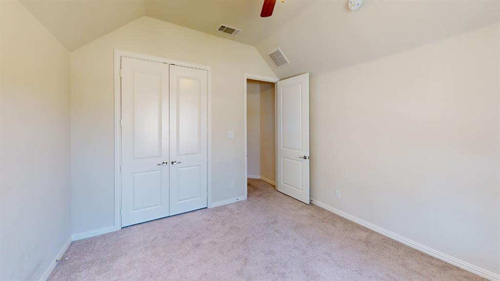 14712 Spitfire Trail Fort Worth, TX 76262 - Photo 19 of 25 Carpeted room with vaulted ceiling and a ceiling fan