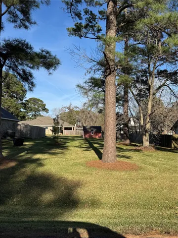 a view of swimming pool with lawn chairs and plants