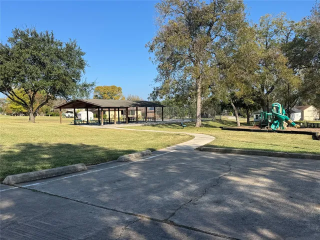 a view of swimming pool with outdoor seating and trees