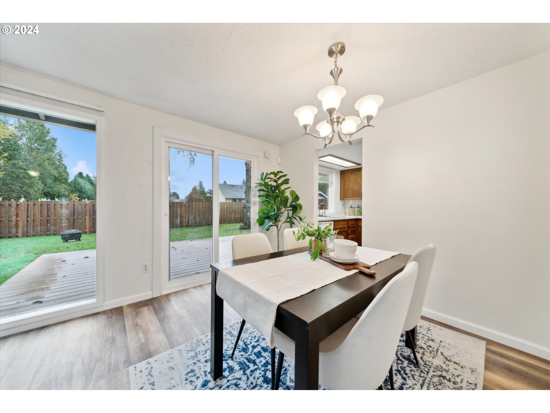 2144 Northeast 38th Drive Gresham, OR 97030 - Photo 5 of 23 a view of a dining room with furniture wooden floor and a chandelier