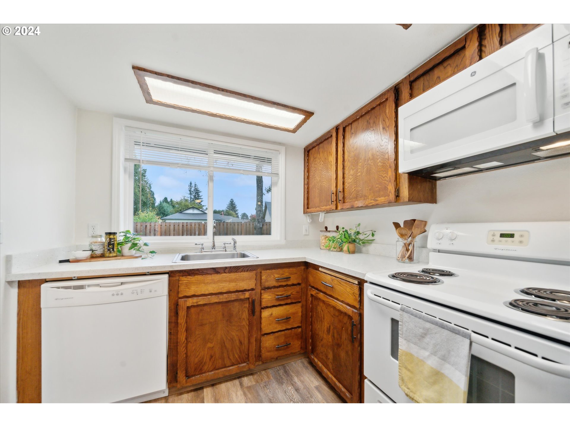 2144 Northeast 38th Drive Gresham, OR 97030 - Photo 7 of 23 a kitchen with a sink stove and cabinets