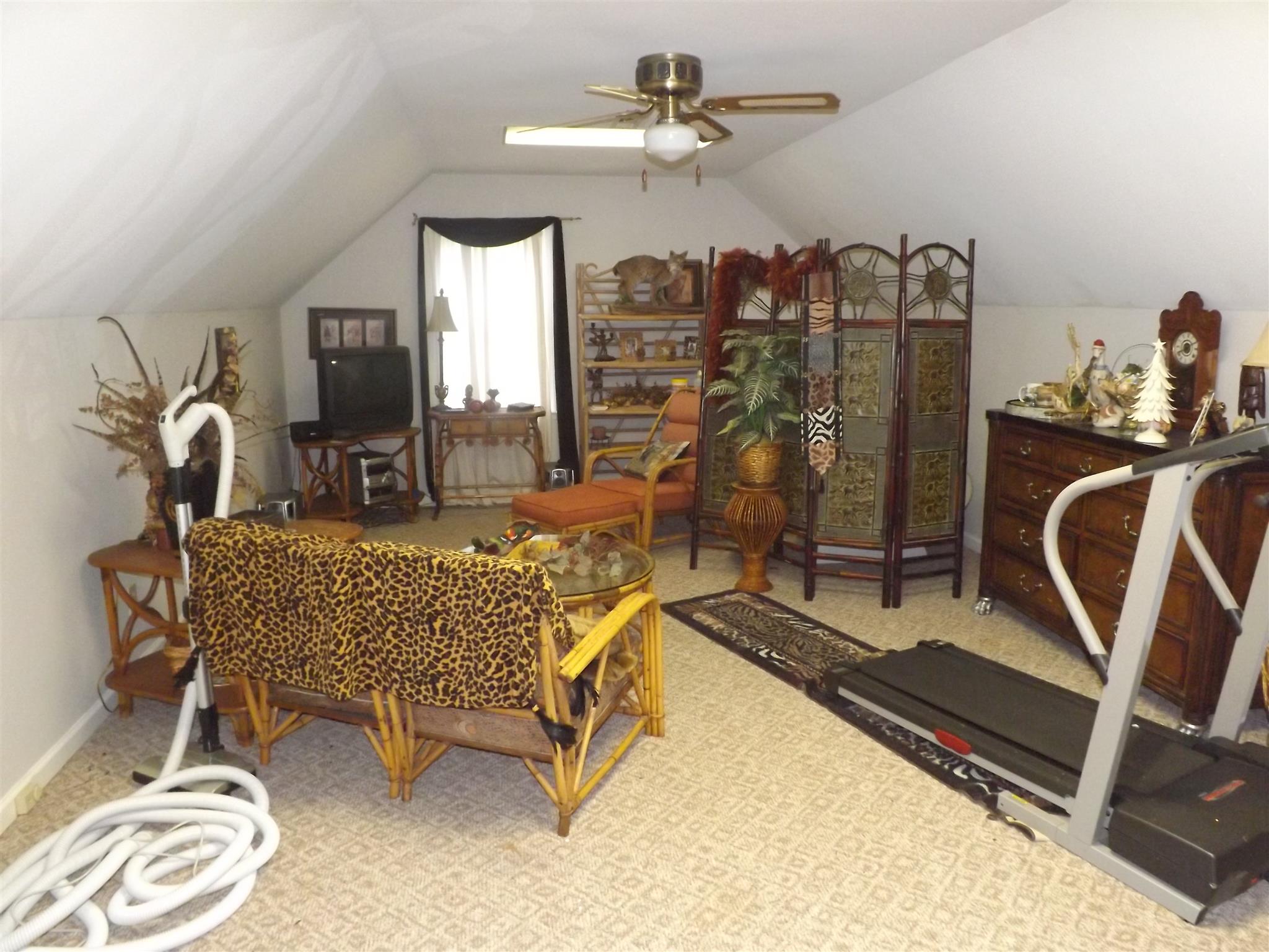 197 Story Road Goodspring, TN 38460 - Photo 22 of 29 a living room with furniture gym equipment and a chandelier