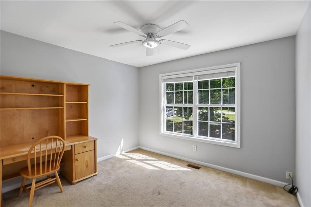 9720 Poole Road Villa Rica, GA 30180 - Photo 19 of 40 an empty room with windows and ceiling fan