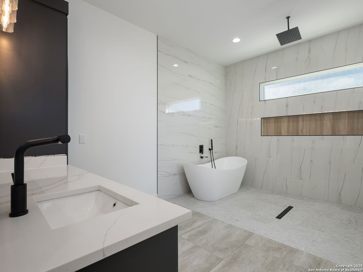 10907 Nina Ridge San Antonio, TX 78255 - Photo 25 of 54 a bathroom with a sink and a bathtub
