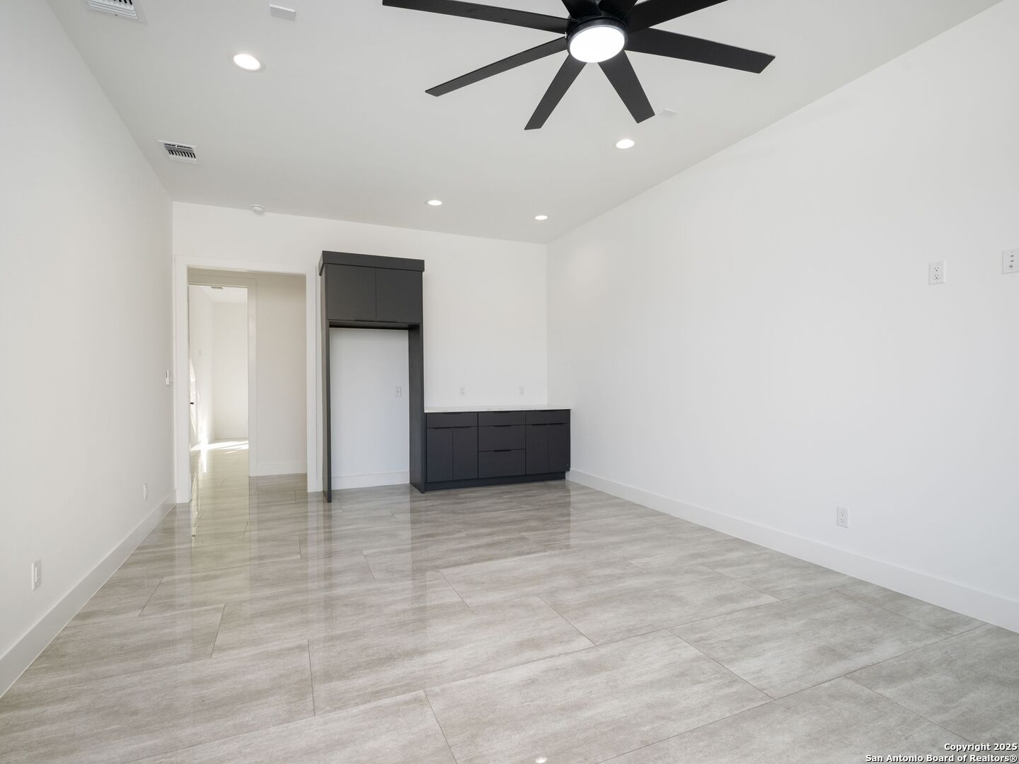 10907 Nina Ridge San Antonio, TX 78255 - Photo 29 of 54 an empty room with wooden floor and windows