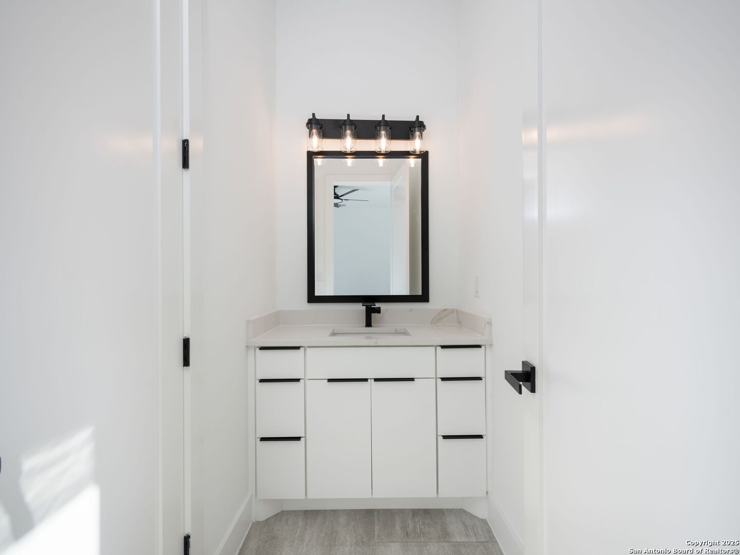 10907 Nina Ridge San Antonio, TX 78255 - Photo 32 of 54 a bathroom with a sink and a mirror