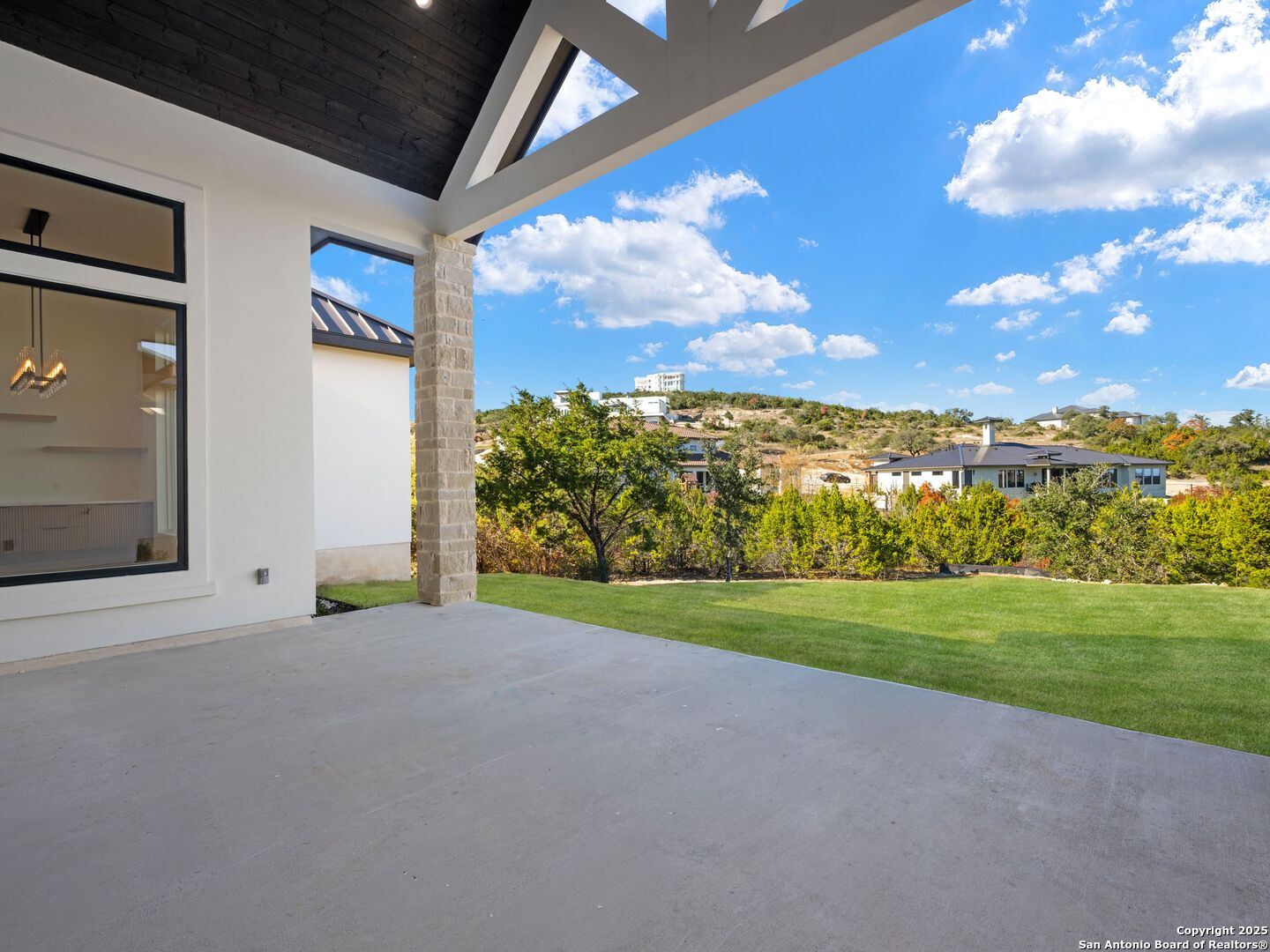 10907 Nina Ridge San Antonio, TX 78255 - Photo 41 of 54 a view of a house with a big yard and large trees