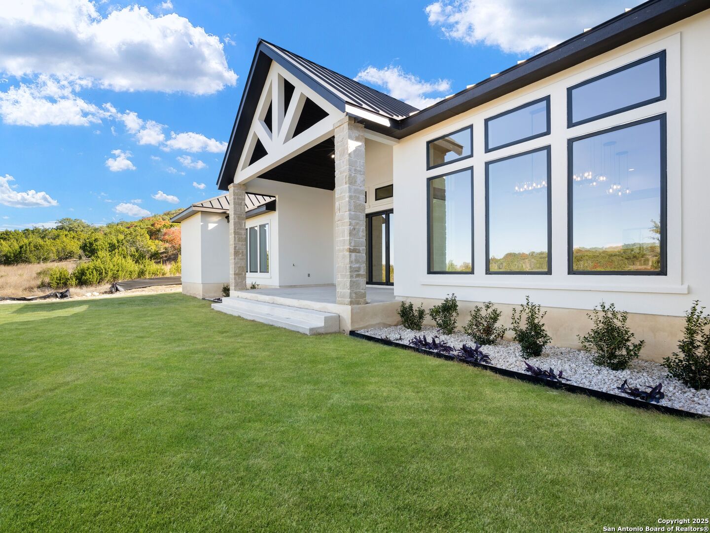 10907 Nina Ridge San Antonio, TX 78255 - Photo 43 of 54 a front view of a house with a yard