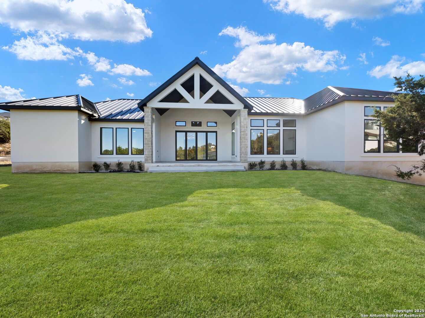 10907 Nina Ridge San Antonio, TX 78255 - Photo 44 of 54 a front view of a house with a yard and trees