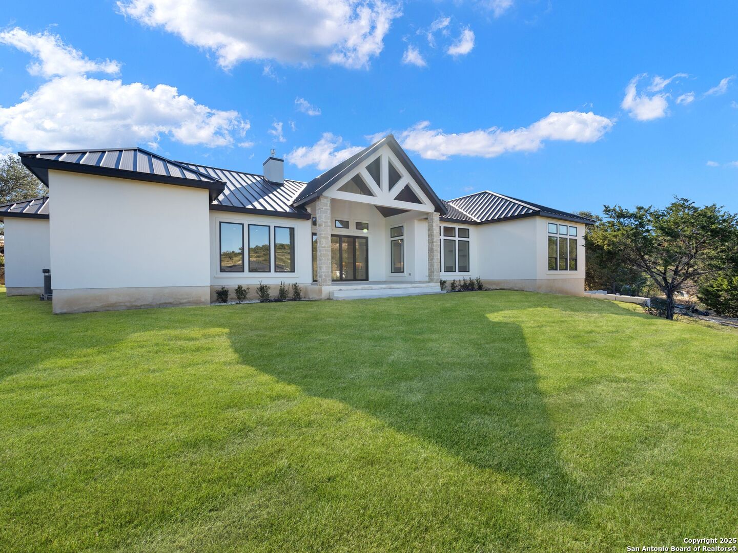 10907 Nina Ridge San Antonio, TX 78255 - Photo 45 of 54 a house with garden in front of it