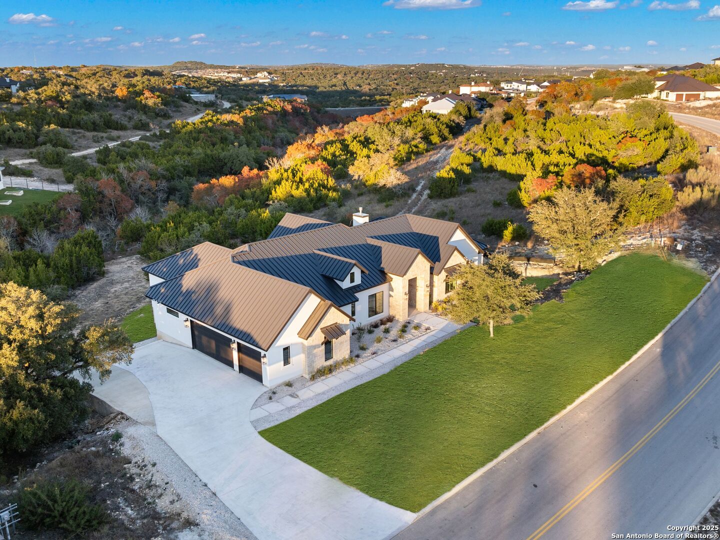 10907 Nina Ridge San Antonio, TX 78255 - Photo 50 of 54 an aerial view of a house with a yard