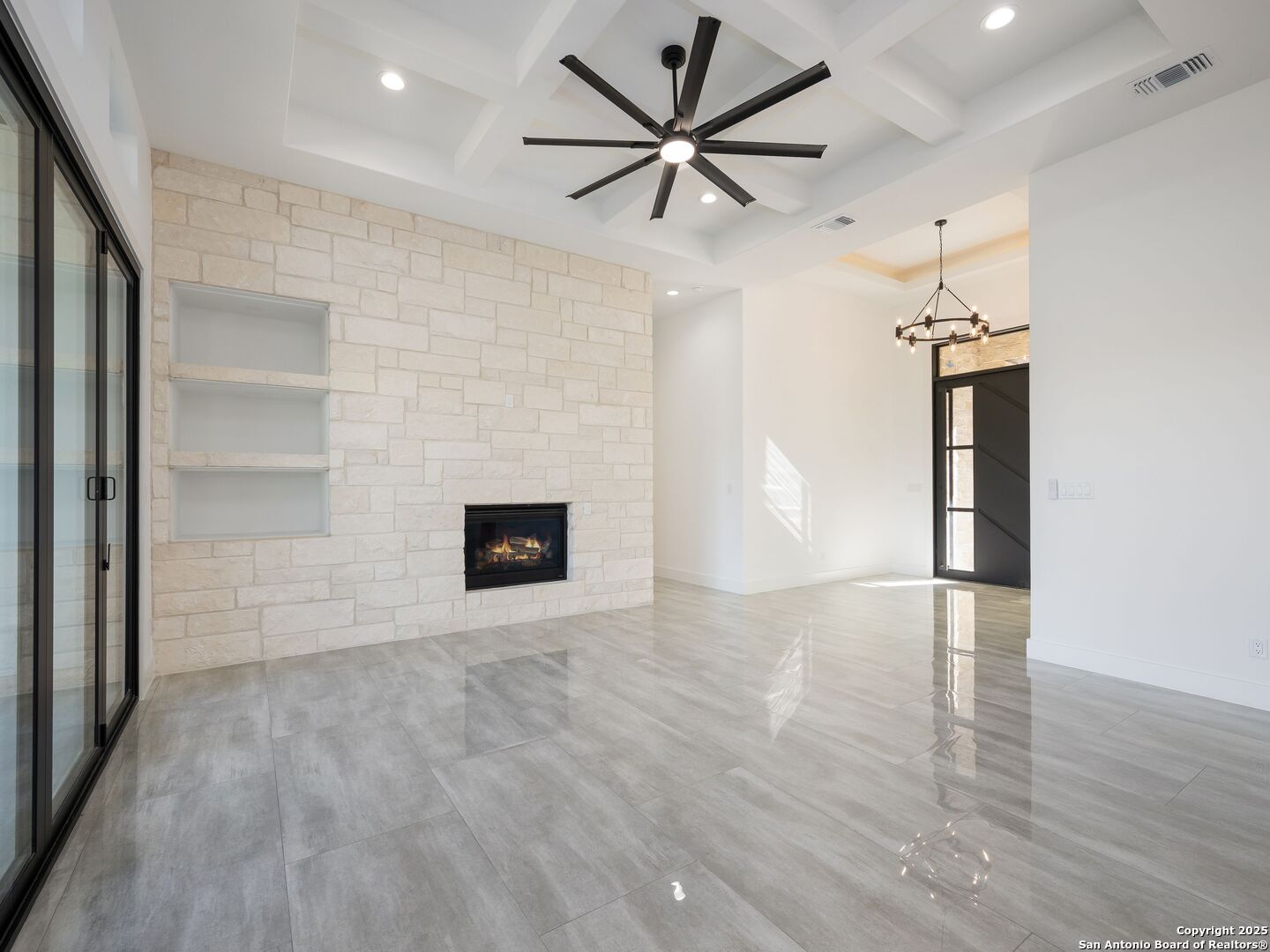 10907 Nina Ridge San Antonio, TX 78255 - Photo 5 of 54 an empty room with windows and fireplace