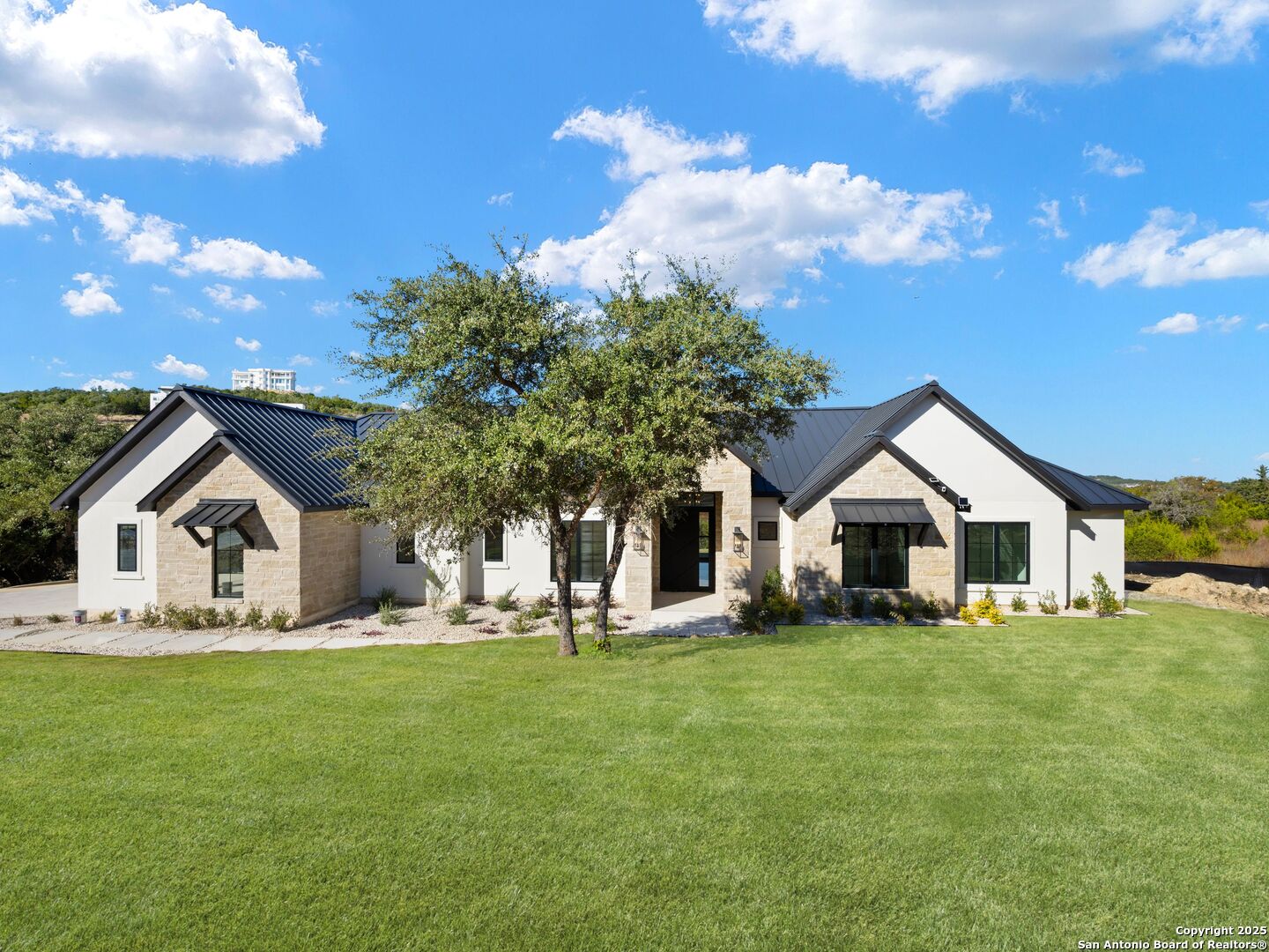 10907 Nina Ridge San Antonio, TX 78255 - Photo 53 of 54 a front view of a house with a yard porch and tree