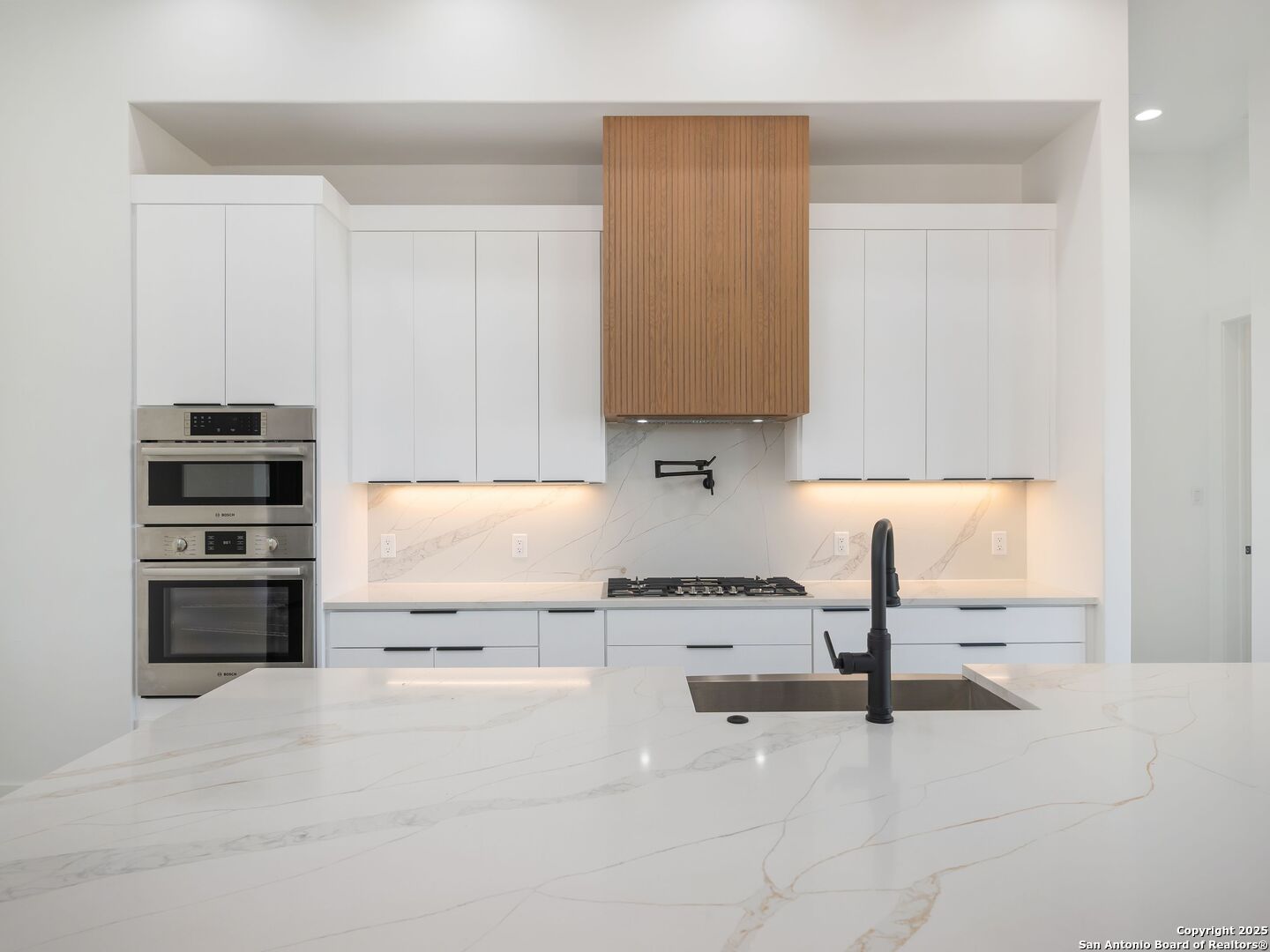 10907 Nina Ridge San Antonio, TX 78255 - Photo 9 of 54 a kitchen with stainless steel appliances a stove a sink and a refrigerator