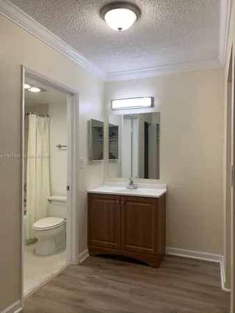 a view of bathroom with a toilet sink and mirror