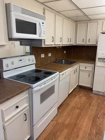 a kitchen with stainless steel appliances granite countertop a sink a stove and microwave