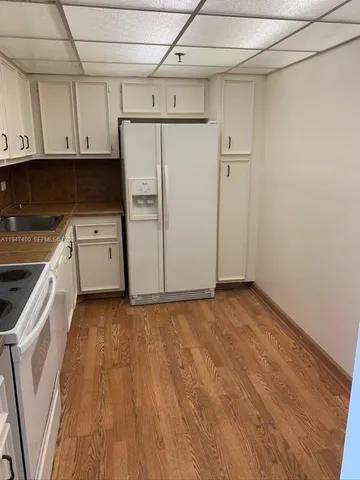 a view of a kitchen with electric appliances