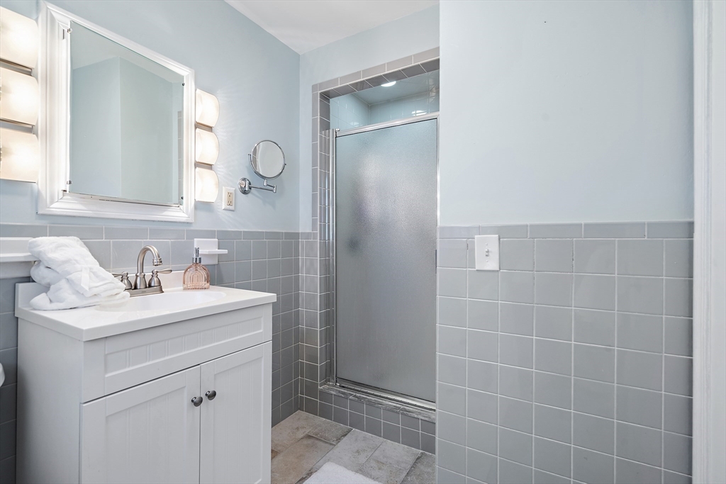 16 Beaudry Street Marlborough, MA 01752 - Photo 16 of 40 a bathroom with a sink a toilet and a mirror