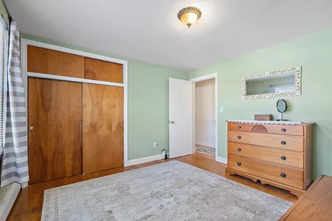 a view of a bedroom with closet and cabinet