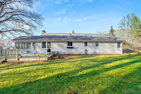 a view of a house with a backyard patio and swimming pool