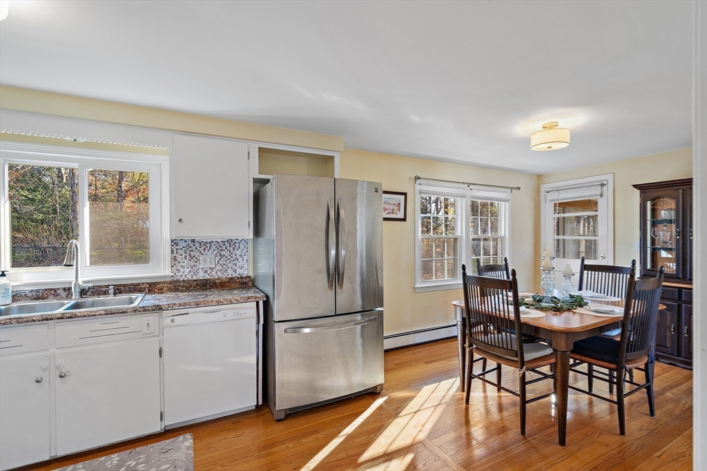 16 Beaudry Street Marlborough, MA 01752 - Photo 10 of 40 a kitchen with a refrigerator a table and chairs
