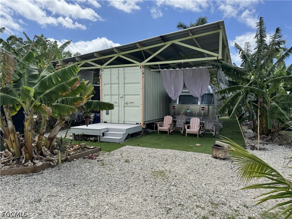 13641 Ficus Tree Lane Bokeelia, FL 33922 - Photo 27 of 33 a view of a chair and table in backyard