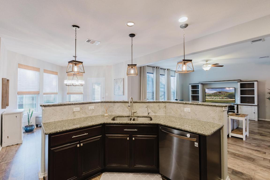 1420 Crested Butte Way Georgetown, TX 78626 - Photo 40 of 40 Kitchen with dishwasher, open floor plan, a kitchen island with sink