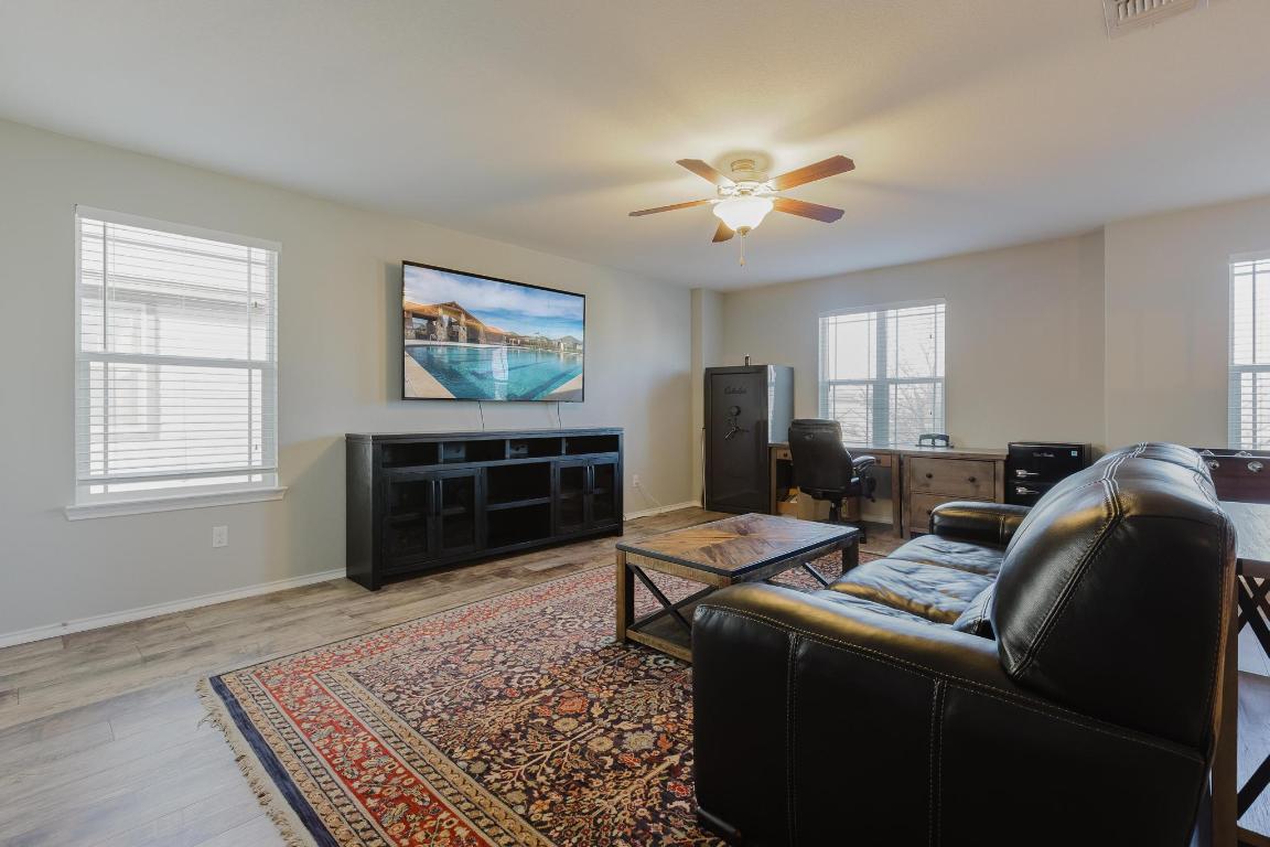 1420 Crested Butte Way Georgetown, TX 78626 - Photo 18 of 40 Flex area with light wood-style flooring, healthy amount of natural light, a ceiling fan, and an office area